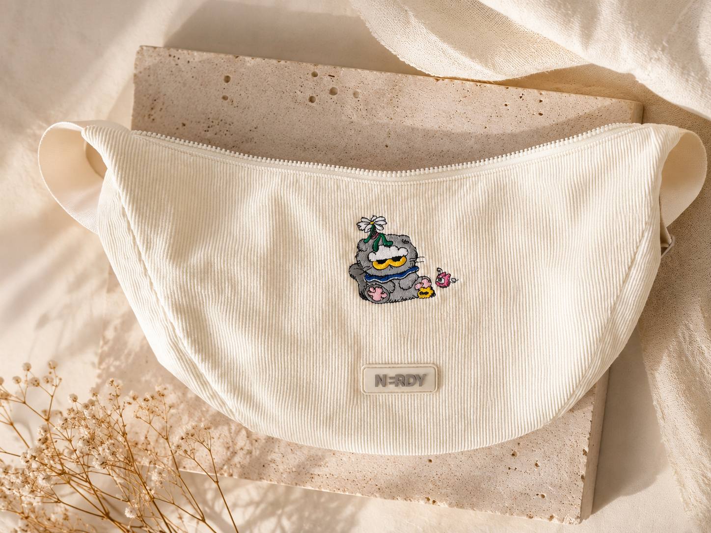 Cream hood with colourful character embroidery